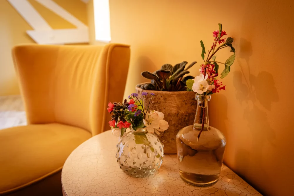 Bloemen en decoratie op een tafeltje in kamer Oppidum